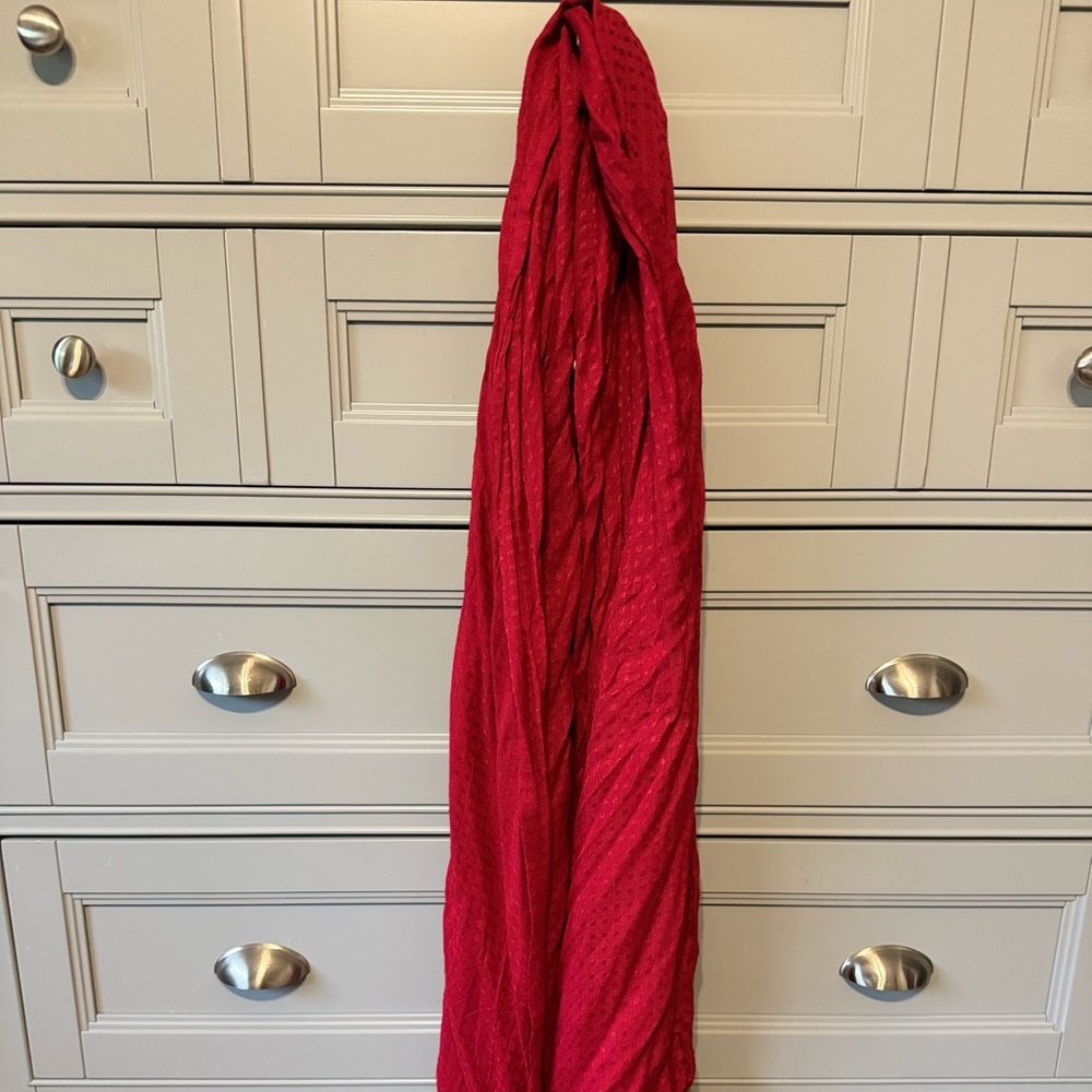 Red neck scarf with fringe detail.